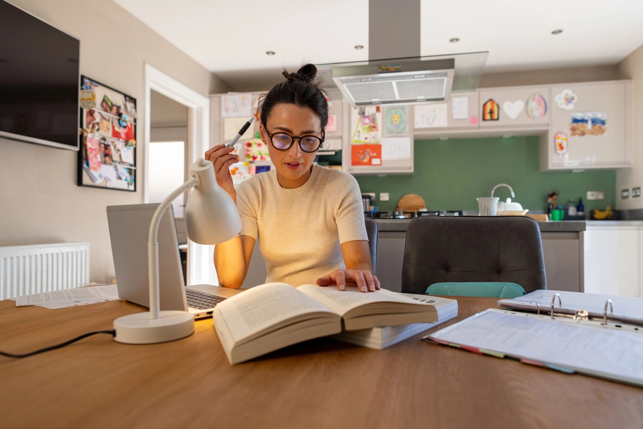 Author reviewing and editing a manuscript at a desk