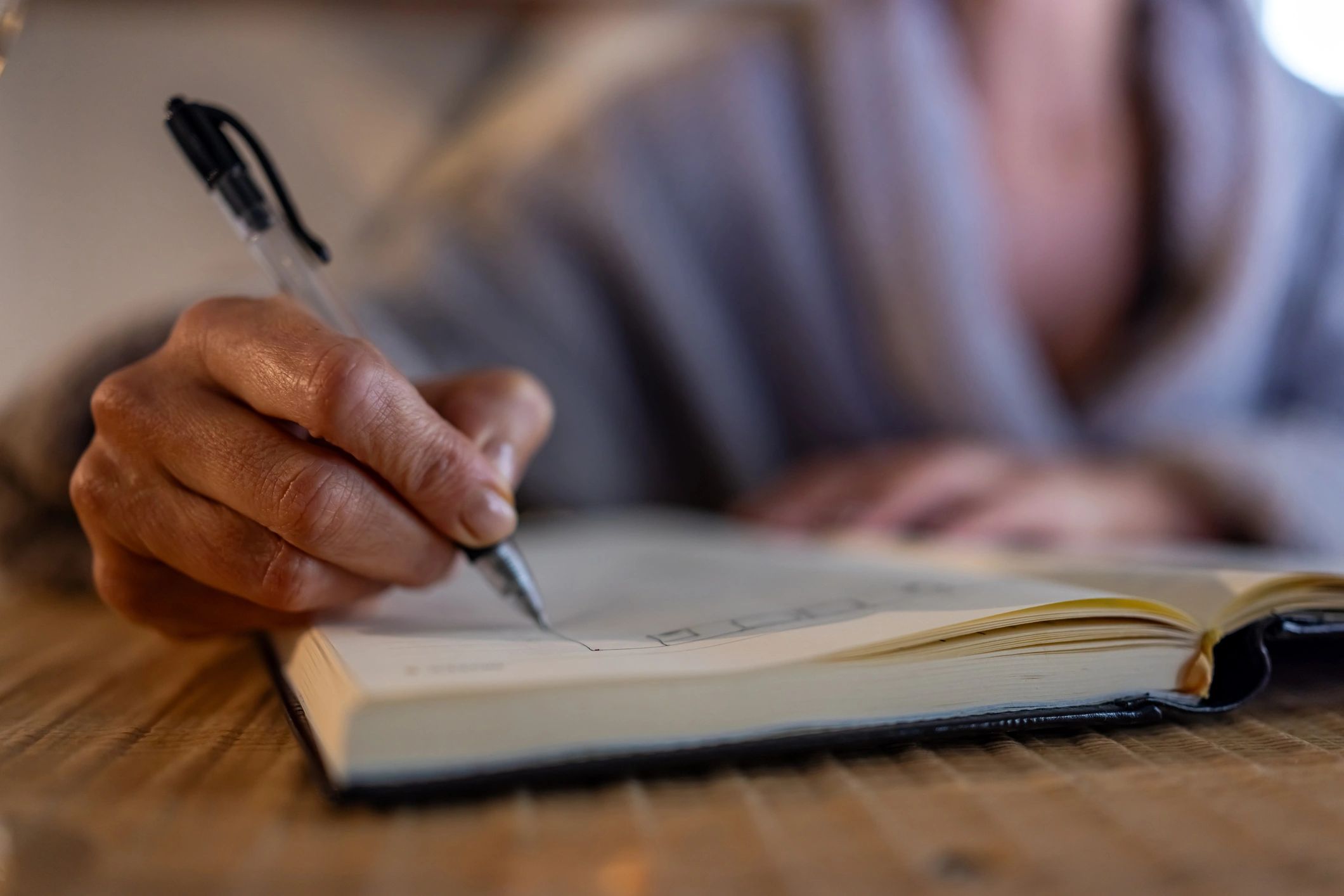 Author writing notes during the editing process